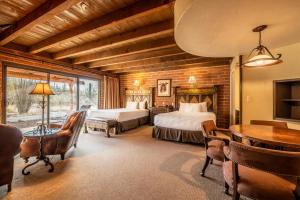 a bedroom with two beds and a table and chairs at Tanque Verde Guest Ranch in Tucson +291 photos