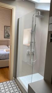 a shower in a bathroom with a bed in a room at Alle scalette in Trieste +47 photos