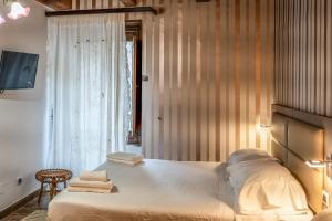 a bedroom with a large bed and a window at Casa Lanzara - Dimora Storica nel cuore del Pollino in Morano Calabro