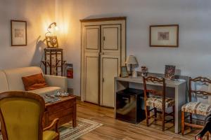 a living room with a table and a fireplace at Casa Lanzara - Dimora Storica nel cuore del Pollino in Morano Calabro