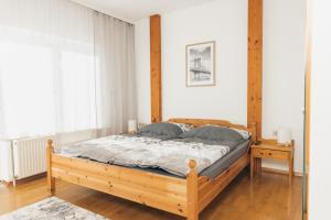 a bedroom with a wooden bed in a room at Ferienlodge bei den Reben in Sankt Margarethen im Burgenland
