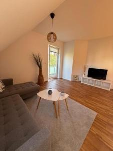 a living room with a couch and a table at Inselhus in Burg auf Fehmarn
