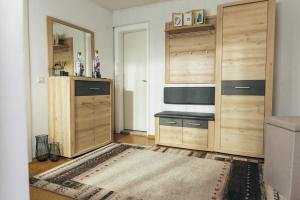 a room with wooden cabinets and a table and a mirror at Ferienlodge bei den Reben in Sankt Margarethen im Burgenland