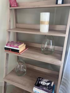 a book shelf with two glasses and books at Modern , Spotless Townhouse in Quiet Estate - Pietermaritzburg in Pietermaritzburg
