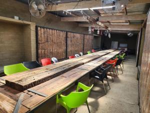 a long wooden table and chairs in a room at Valley Croft Farm in Hekpoort +28 photos