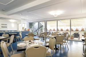 a restaurant with tables and chairs and windows at Palazzo Turchini in Naples