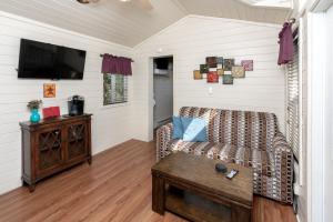 a living room with a couch and a coffee table at Sun Outdoors Central Coast Wine Country in Paso Robles
