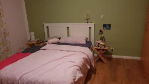 a bedroom with a bed and two night stands at Zimmer an der Wedel in Burgwedel