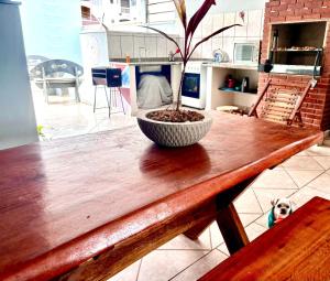 a wooden table with a potted plant on top of it at Solar Boutique Residence in Pouso Alegre +14 photos