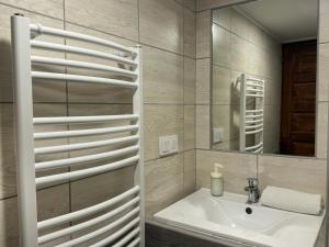 a bathroom with a sink and a mirror at Centrum Rezidencia Pápa in Pápa +24 photos