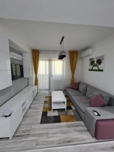 a living room with a couch and a table at Romanescu Park Apartament in Craiova