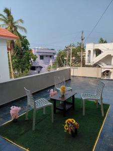 a patio with two chairs and a table on a roof at Elite stay villa in Vākalapūdi