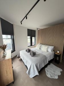 a bedroom with a large white bed with two pillows at 70 Bath Street in Saint Helier Jersey
