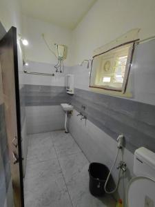 a small bathroom with a sink and a mirror at Elite stay villa in Vākalapūdi +12 photos