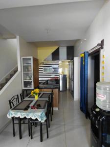 a kitchen with tables and chairs in a room at Elite stay villa in Vākalapūdi