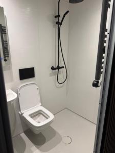 a white bathroom with a toilet and a shower at 70 Bath Street in Saint Helier Jersey +7 photos