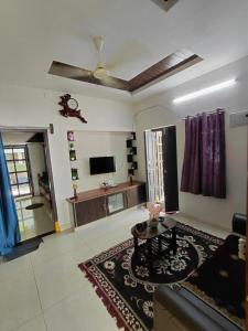 a living room with a couch and a table at Elite stay villa in Vākalapūdi