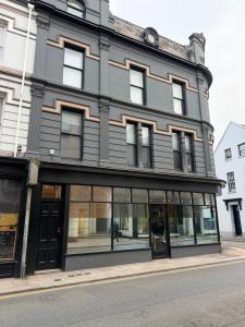 a large gray building with windows on a street at 70 Bath Street in Saint Helier Jersey