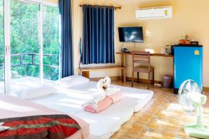 a hotel room with two beds and a balcony at Ingtarn Ressort At thasala อิงธารรีสอร์ท ท่าศาลา in Ban Nai Thung +63 photos