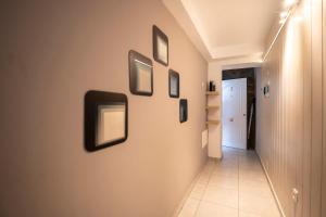 a hallway with framed pictures on the wall at Edificio Prieto VIV 7 in Puerto del Rosario