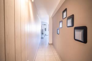 a hallway with pictures on the walls of a building at Edificio Prieto VIV 7 in Puerto del Rosario