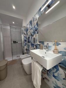 a bathroom with a sink and a toilet and a shower at Donna Dina in Avola +18 photos