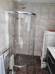 a shower with a glass door in a bathroom at La Flottille, La Cotinière in La Cotinière +39 photos