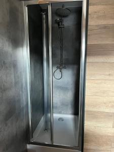 a shower with a glass door in a room at Nad Stawami - studio in Białowieża +7 photos