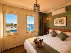 a bedroom with a bed with a basket on it at Bozcaada Aspava Otel in Bozcaada