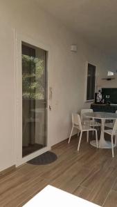 a living room with a table and chairs and a kitchen at Residenza Villa Terry in Vieste