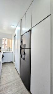 a kitchen with a refrigerator in the middle of a room at Comodidades, modernidad, céntrico in Caracas