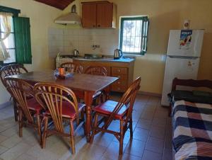 a kitchen with a table and chairs and a refrigerator at Finca Re Mar 1 in Santa Ana