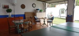 a dining room with tables and chairs in a room at Casa Rural La Gospa in Urda