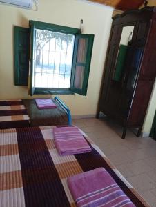 a room with three beds and a window at Finca Re Mar 1 in Santa Ana