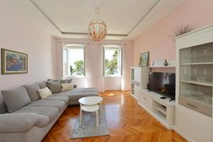 a living room with a couch and a tv at Apartment Nikki Kolovare Beach in Zadar