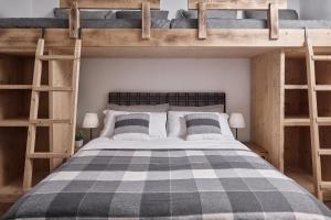 two bunk beds in a room with a bed at Alp Tirol Home in Pellizzano