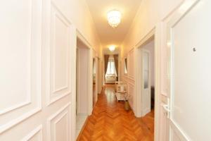 a hallway with white doors and a hard wood floor at Apartment Nikki Kolovare Beach in Zadar