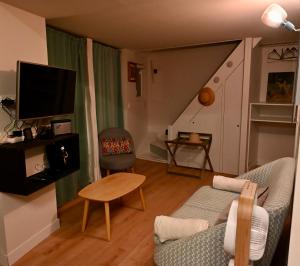 a living room with a couch and a chair at Gîte Marangate Numéro 1 in Bazenville