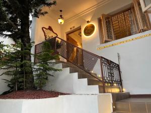 a house with a staircase in front of a building at Leclerc Hotel Boutique Cali Granada in Cali