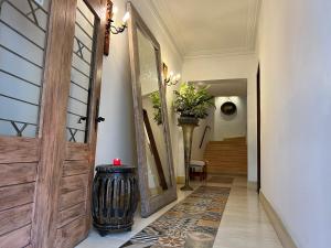 a hallway with a wooden door and a vase at Leclerc Hotel Boutique Cali Granada in Cali +82 photos