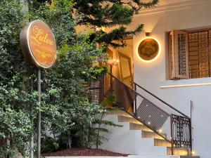 a sign for a restaurant next to a building at Leclerc Hotel Boutique Cali Granada in Cali