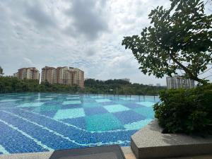 a large swimming pool with blue tiles on it at ANTARA Muji Serenity Condo in Putrajaya