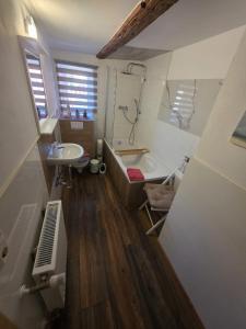 a bathroom with a bath tub and a sink at Fewo's kleine Auszeit in Quedlinburg +58 photos