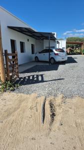 a white car parked in front of a house at El hogarcito in Cafayate
