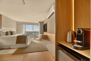 a hotel room with a bed and a balcony at Venti Hotel - By Brisa Hotéis - Soft Opening in Maceió
