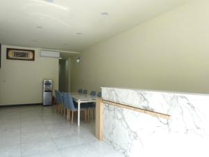 a dining room with a marble table and chairs at Travel Island B&B in Beigan
