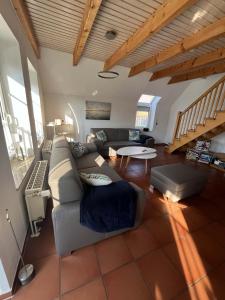 a living room with a couch and a table at SörenHuus Neßmersiel in Dornum