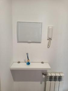 a white bathroom with a sink and a mirror at dpCristal Sarria Centro in Sarria +52 photos