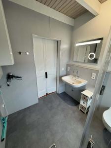 a bathroom with a sink and a toilet at SörenHuus Neßmersiel in Dornum