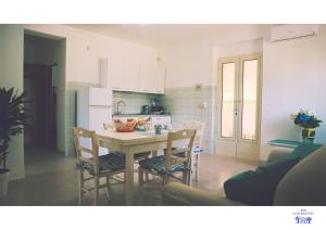 a kitchen and dining room with a table and chairs at B&B Corte degli Ulivi in Mattinata +20 photos